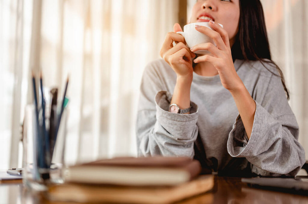 Woman holding a coffee cup work from home wait epidemic situation to improve soon at home. Coronavirus, covid-19, Work from home (WFH), Social distancing, Quarantine, Prevent infection concept. - Zdjęcie, obraz