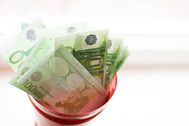 Moneybox, Euro bill in bucket on white window.light background (англійською). місце для тексту. вид зверху. Купа грошей. - Фото, зображення