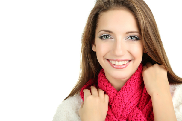 Beautiful smiling girl in warm knit scarf isolated on white - 写真・画像
