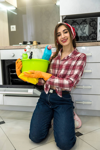 Trabajo doméstico. Joven esposa limpiando su cocina con trapo y detergente - Foto, Imagen