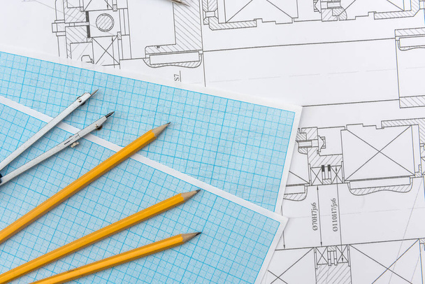 Technical drawing, graph paper and tools. Engineer  office team working with blueprints. - Photo, Image