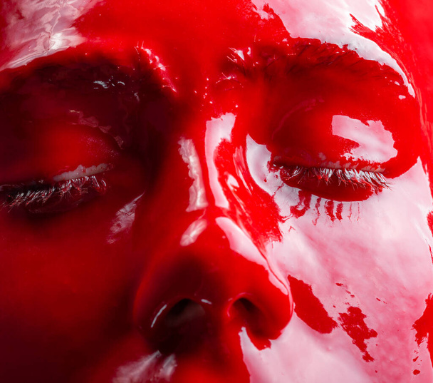 Изображение лица девушки с красной глянцевой краской, крупным планом
 - Фото, изображение