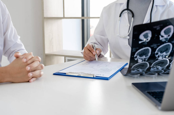 Il medico valuta la radiografia cerebrale e consiglia i pazienti sull'assistenza sanitaria
. - Foto, immagini