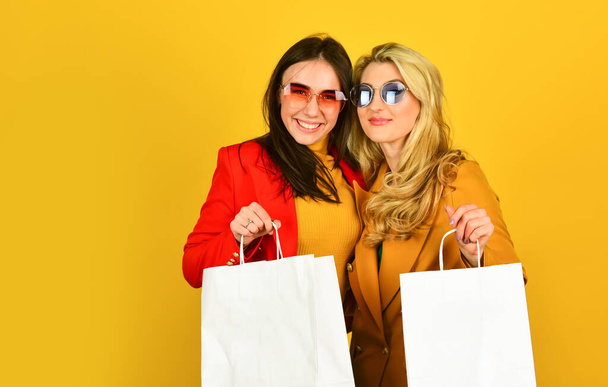 Black friday. Women in spring jacket. Promoting product. Girls shopping. Shopping mall. Luxury boutique. Great offer. Look Sophisticated. Go for shopping. Spring shopping sales. Fun and gifts - 写真・画像