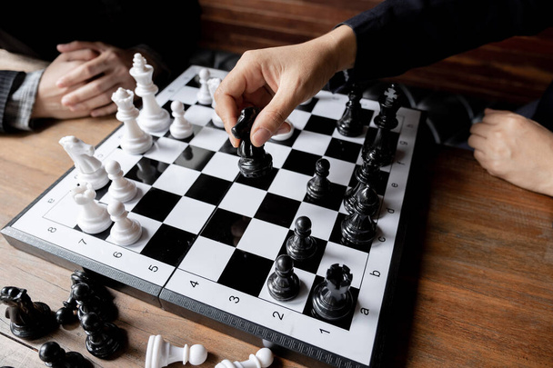 Business women play chess on board with white background, challenges planning business strategy to success concept. - Photo, Image