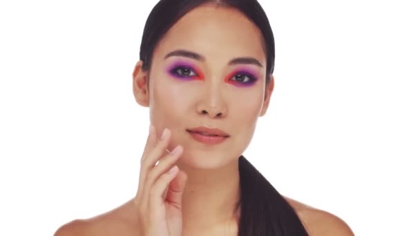 A beautiful young half-naked woman with bright fashion eye makeup is doing a kiss to the camera isolated over white background - Séquence, vidéo