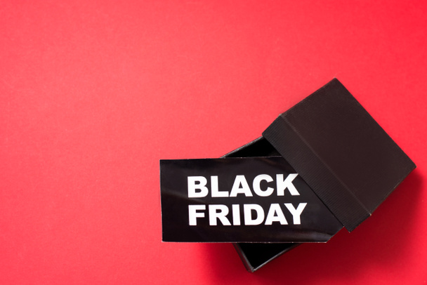 Black friday. Sale tag in box on the red background,copy space. - Foto, Imagem