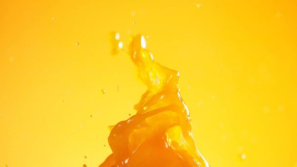Pouring orange juice splash, isolated on coloured background - Φωτογραφία, εικόνα