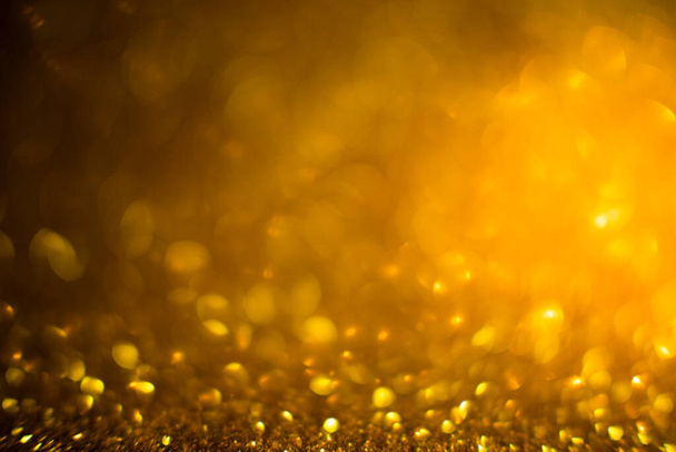 Abstract of Bright and sparkling bokeh background. golden and diamond dust bokeh - blurred lighting from glitter texture. Blue color Luxury design background. Gold festive glitter background with bokeh golden lights. - Fotó, kép