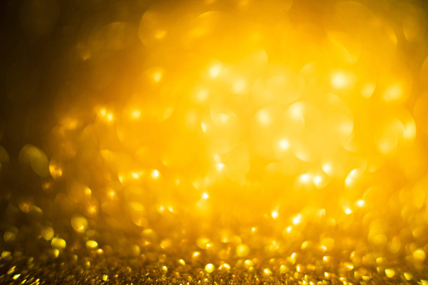 Abstract of Bright and sparkling bokeh background. golden and diamond dust bokeh - blurred lighting from glitter texture. Blue color Luxury design background. Gold festive glitter background with bokeh golden lights. - Foto, afbeelding