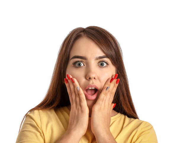 Portrait of surprised young woman on white background - Photo, image