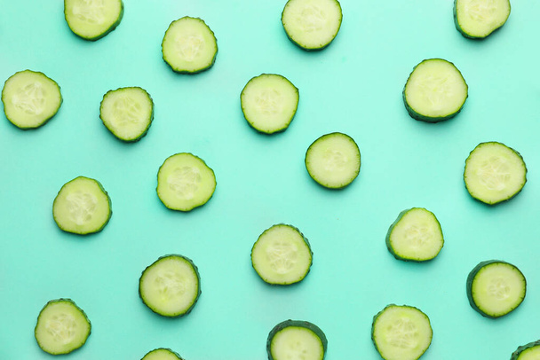 Green cut cucumbers on color background - Zdjęcie, obraz