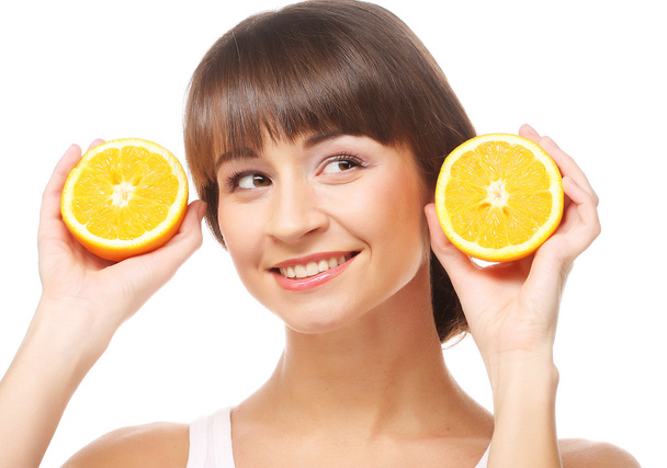 Young cheerful woman with oranges - Φωτογραφία, εικόνα