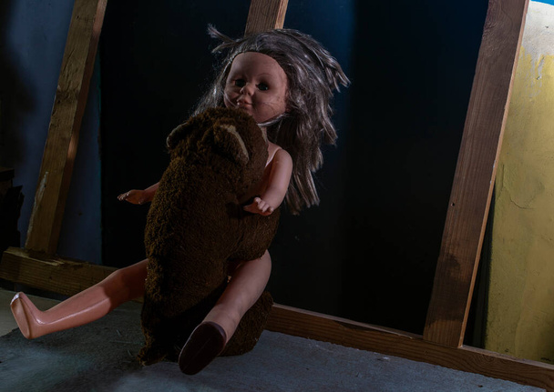 A bear doll will rape a girl doll in the basement.  Toys. - Photo, Image