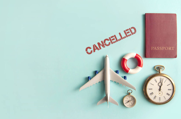 Cancelled stamped by travel assessories including miniature airplane, clock and passport with space  - Фото, зображення