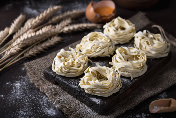 Uncooked homemade pasta tagliatelle - Fotoğraf, Görsel