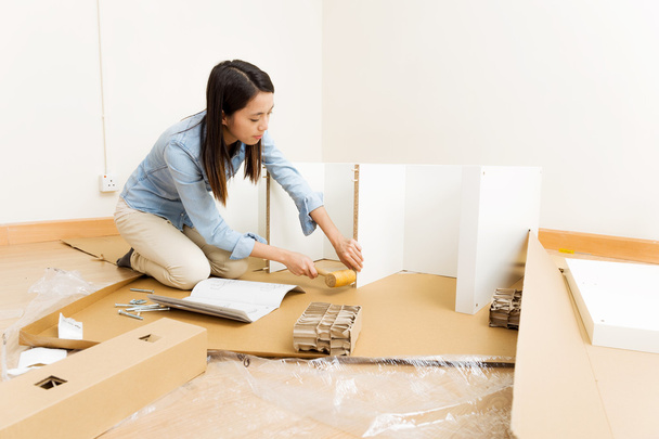Asian woman using hammer for assembling furniture - Photo, Image