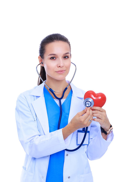 A doctor with stethoscope examining red heart, isolated on white background - Foto, Imagen