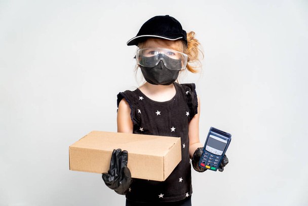 contactless payment. Little girl is delivery man.  - Photo, Image