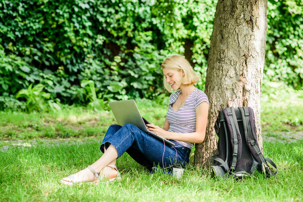 Nature essential wellbeing and ability be productive. Girl work with laptop in park. Reasons why you should take your work outside. Woman student sit on grass while study. Work in summer park - Photo, image