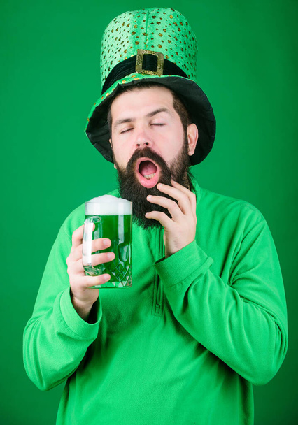 Man brutal bearded hipster drink beer. Irish pub. Drinking beer part celebration. Fest and holiday menu. Dyed green traditional beer. Lets start patricks party. Alcohol beverage. Irish tradition - Фото, изображение