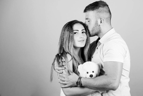 Enjoying each other. Happy family. Valentines day holiday. Soft toy teddy bear gift. Man and woman couple in love. Family love. Romantic surprise. Man and pretty girl in love. Guy and girl cuddling - Fotografie, Obrázek