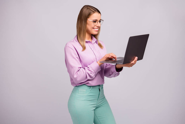 Portrait of positive confident smart manager girl work distance use laptop read social blogging news wear mint violet clothes isolated over gray color background - Foto, immagini