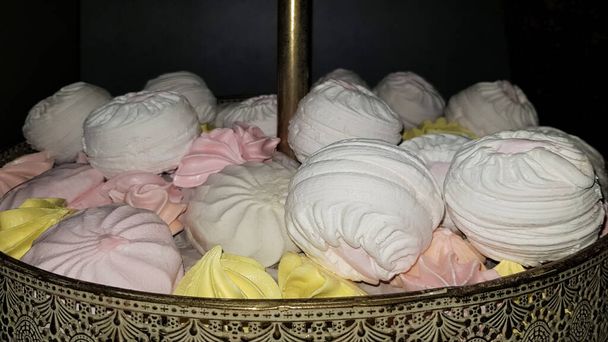 Color sweet homemade meringues and marshmallows. Airy and tender pastry marshmallows dessert. The sweet dish you want to eat. Sweets in the dark - Photo, Image