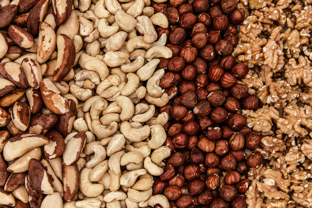 Background of raw nuts, walnuts, hazelnuts, Brazil nuts, cashew - Valokuva, kuva