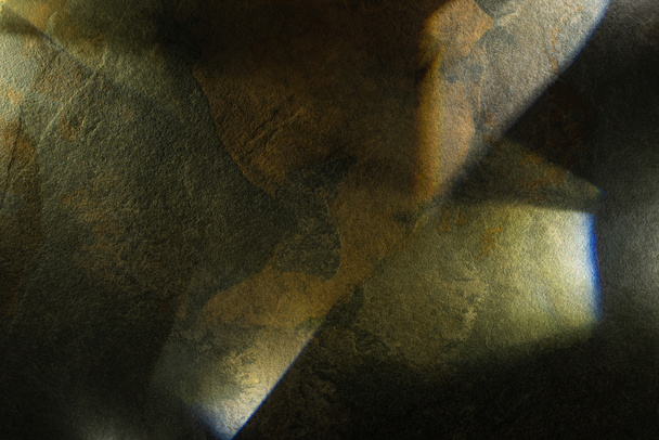 light prism with beams on dark stone texture background - Foto, imagen