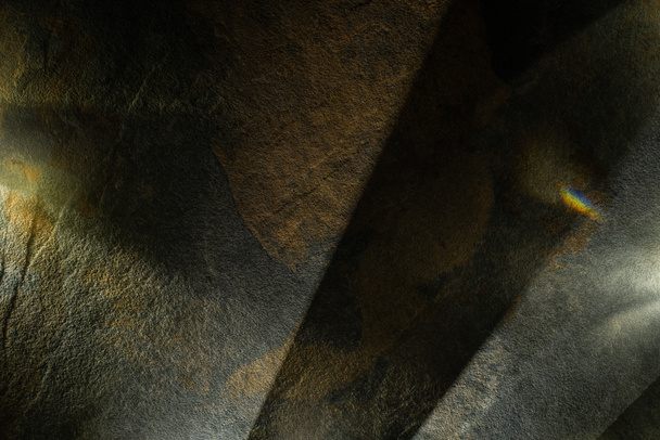 light prism with beams on dark stone texture background - Фото, зображення