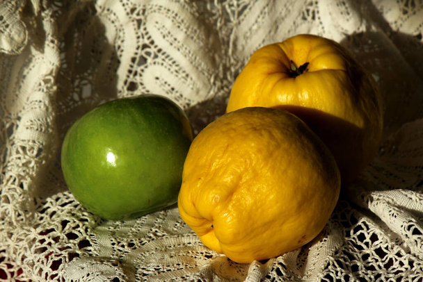Membrillo de frutas y manzana verde en la mesa. Textura de tela de fondo. Bodegón con espacio de copia
.  - Foto, imagen
