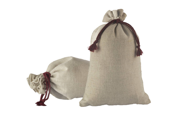 Two decorative bags tied with a lace of rough fabric isolated on a white background. - Photo, Image