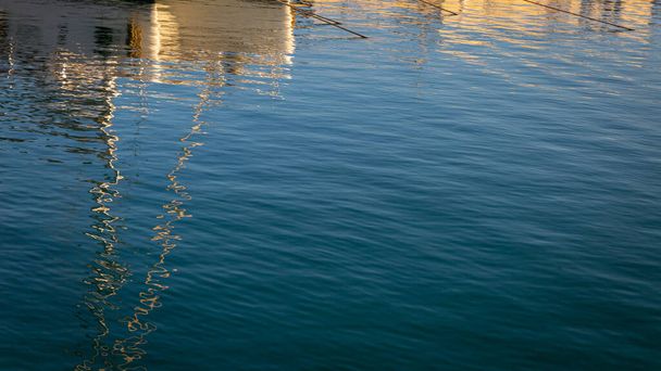 Reflections of boats in the harbor on sea water - Photo, Image