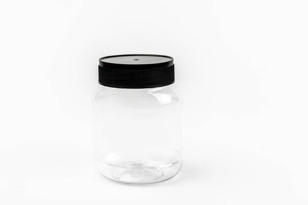 empty transparent plastic jar on white background - Foto, imagen