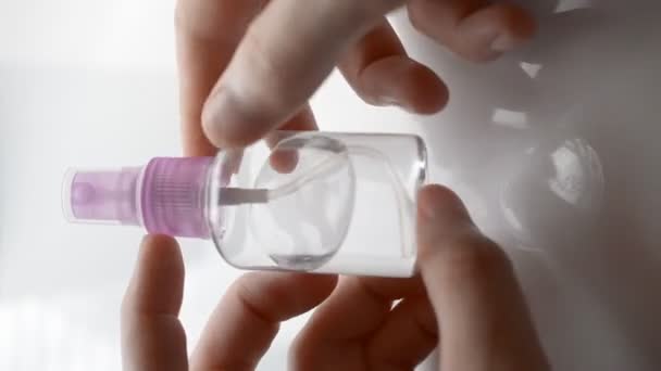 Man cleans hands with antiseptic bottle spraying - Felvétel, videó