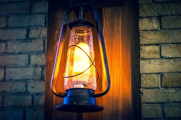 Lamp in the old style on the wall. Restaurant interior in the morning. - Photo, Image