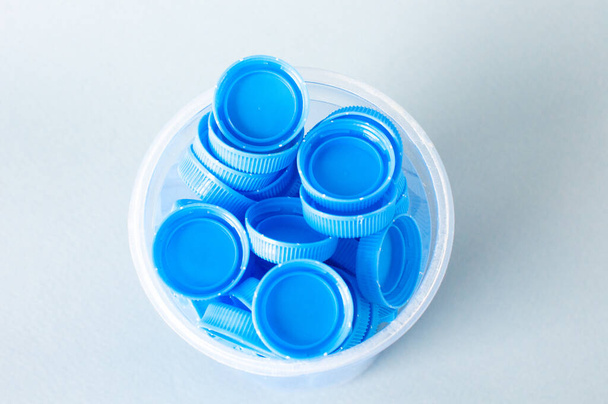 Plastic bottle caps background. Cap material is recyclable.Remove lids from plastic bottles before recycling them. Recycling collection and processing plastic bottle caps. - Valokuva, kuva