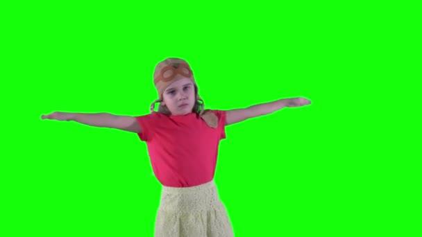 Cute little dreamer kid girl wearing pink helmet pretend flying with airplane - Footage, Video