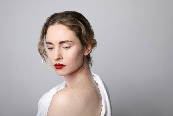 Beauty portrait of young woman with red lips wearing white clothing. Close-up portrait. Space for text. - Фото, зображення