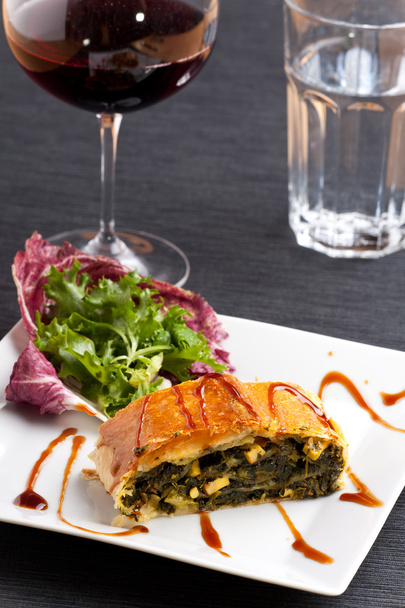 Slice of a spinach strudel on a plate - Photo, image