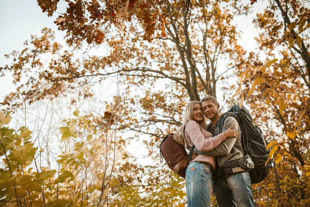 Man And Woman Hugs Standing In Autumn Forest - Φωτογραφία, εικόνα