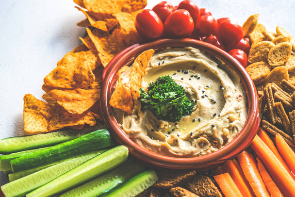 Traditional chickpeas hummus with olive oil and sesame seeds on stone background with copy space - Foto, Imagen