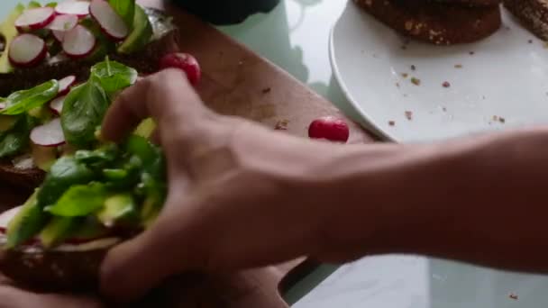 Top view of chef making delicious vegan tartine sandwich - Materiał filmowy, wideo