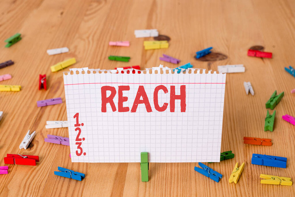 Conceptual hand writing showing Reach. Business photo showcasing the distance within which something can be touched or grabbed Colored crumpled papers wooden floor background clothespin. - Photo, Image