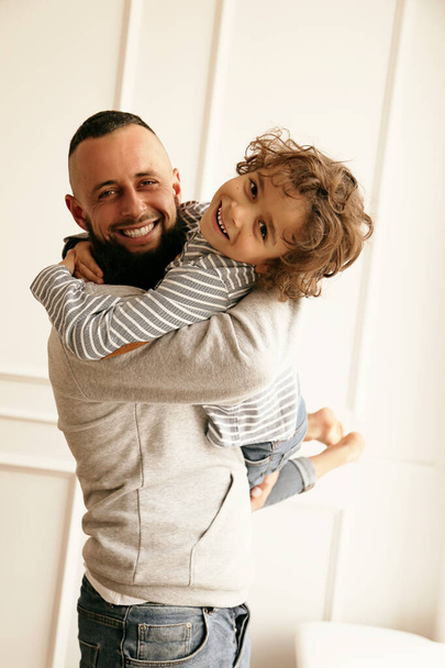 fashion photo of beautiful family. father having fun with cute little boy - Foto, afbeelding