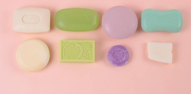 Hygiene and prevention of viral diseases concept. Various soap bar on a pink background. Top view with copy space.Banner - Φωτογραφία, εικόνα