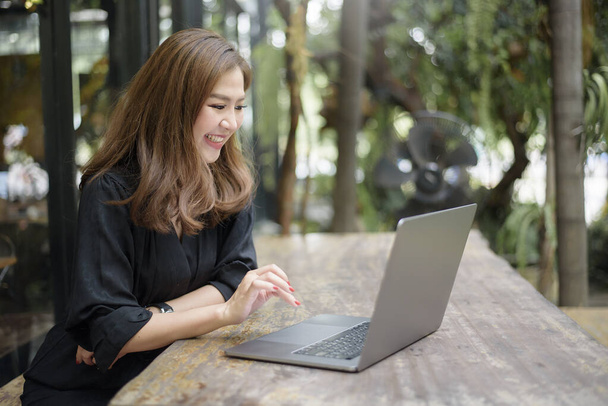 Smart Asian female is working with laptop computer  - Foto, Imagen