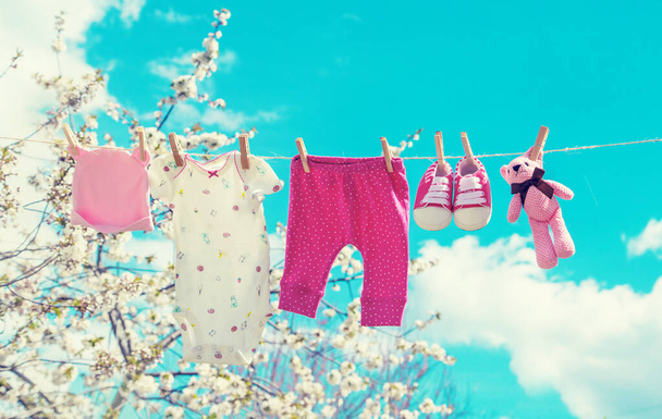 Baby clothes are drying on the street. Selective focus. nature. - Photo, Image