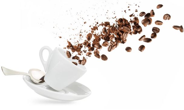 κόκκοι καφέ και σκόνη χυθεί από ένα κύπελλο που απομονώνονται σε λευκό - Φωτογραφία, εικόνα